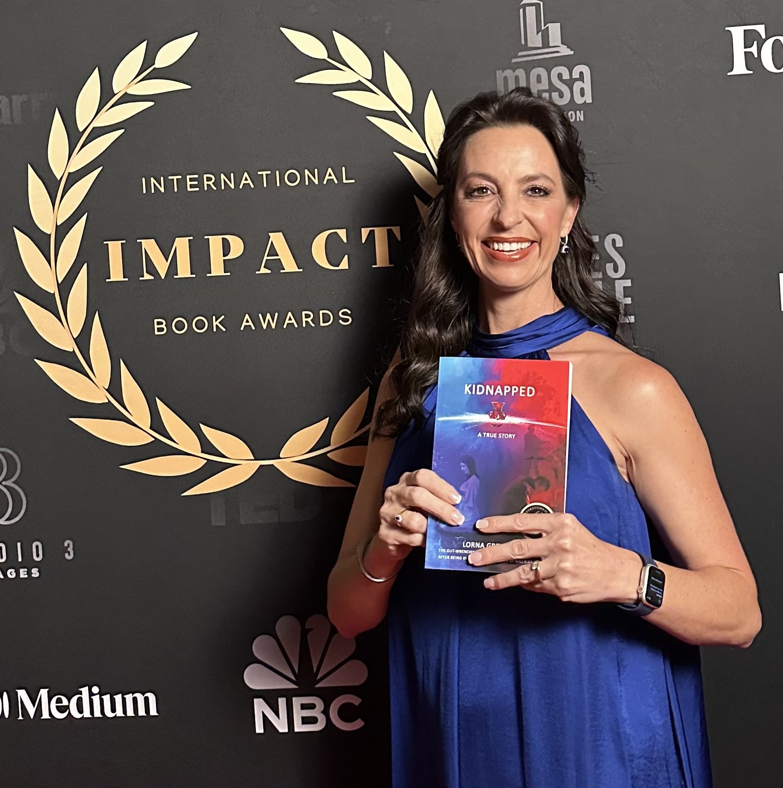 Lorna Greyling holding her book Kidnapped at the International Impact Book Awards